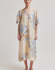 Woman wearing a floral dress with a plain background